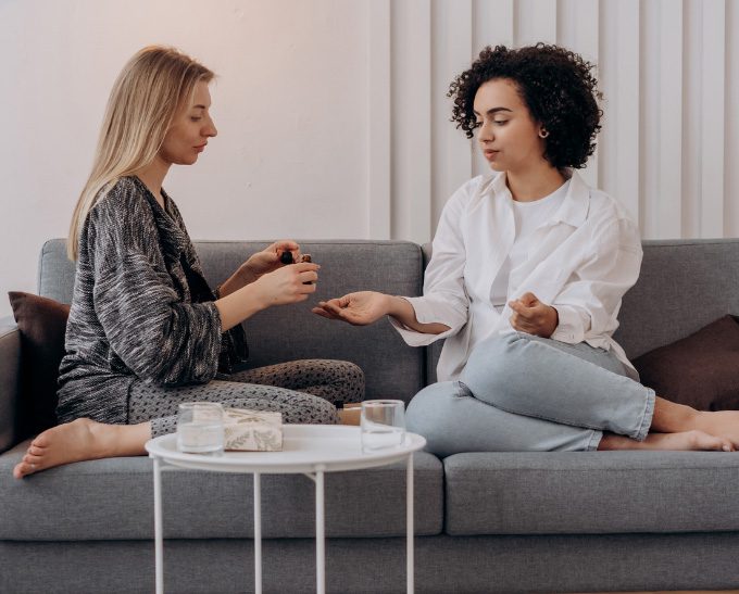 women trying essential oils