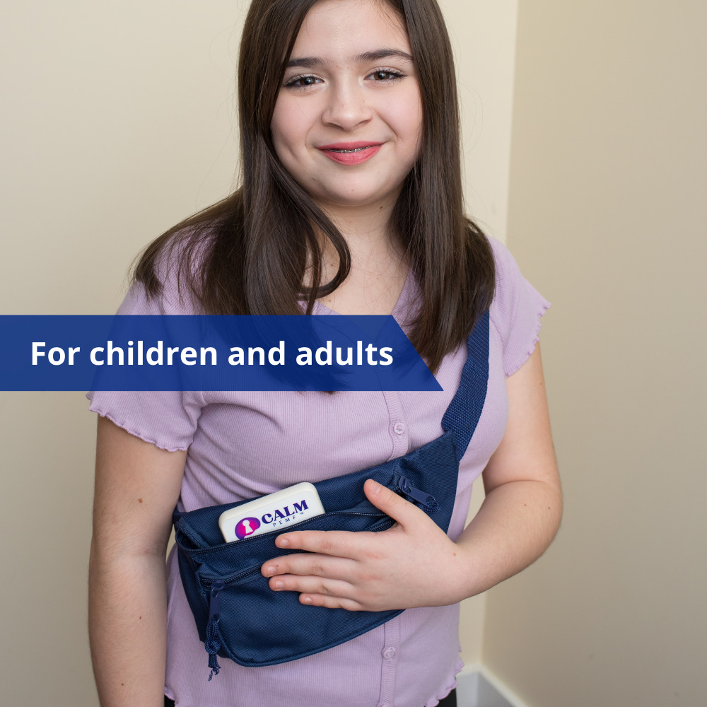 A young girl holding a blue Calm PEMF™ device designed for Attention and Learning.