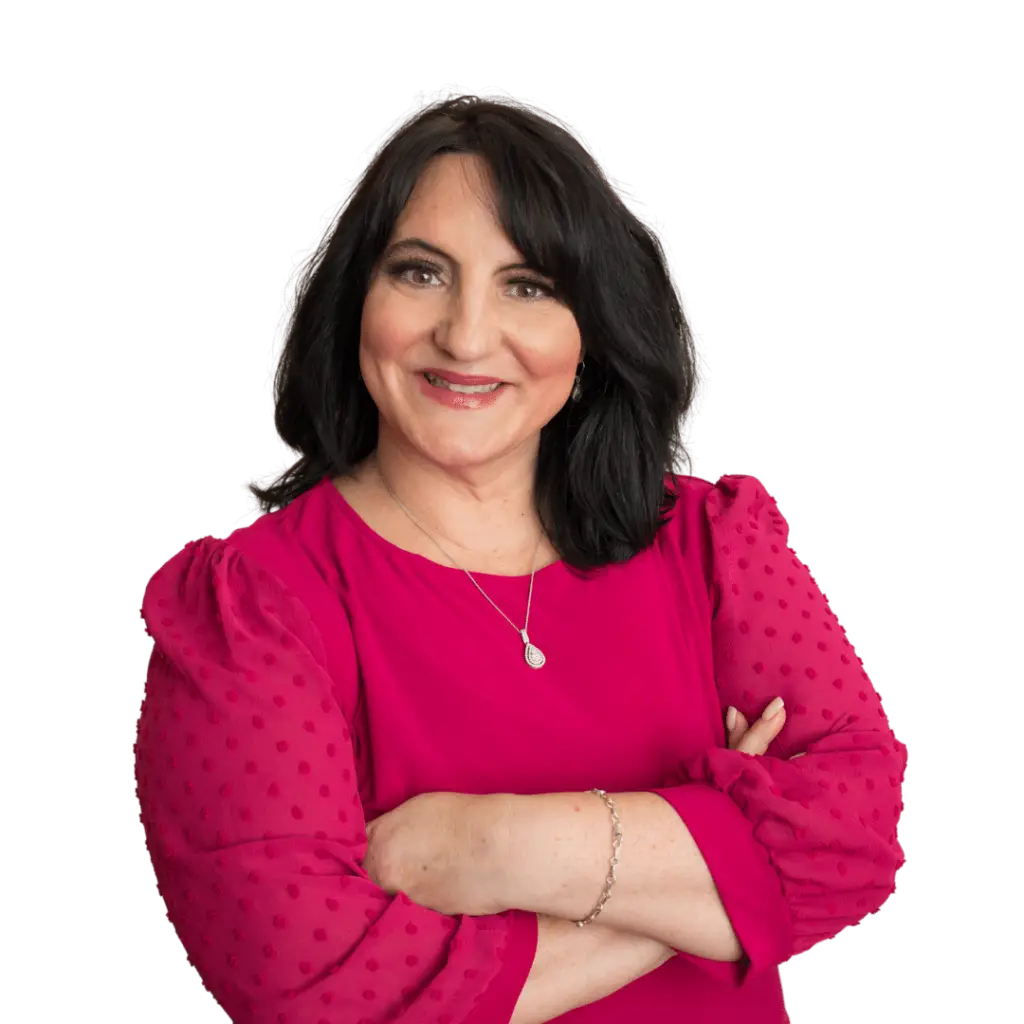 A woman receiving stress treatments, with her arms crossed and wearing a red top.