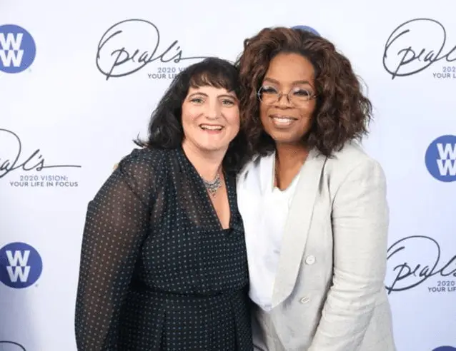 Two women posing for a photo promoting Kid's Mental Health Solutions at an event.