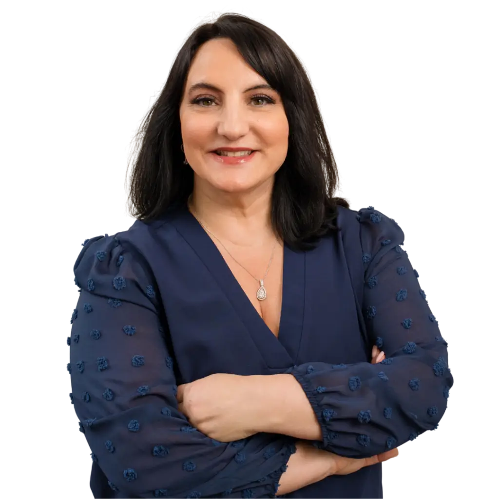 Portrait of Dr. Roseann Capanna-Hodge standing confidently with arms crossed, smiling warmly, dressed professionally, conveying expertise, compassion, and authority in mental health care.