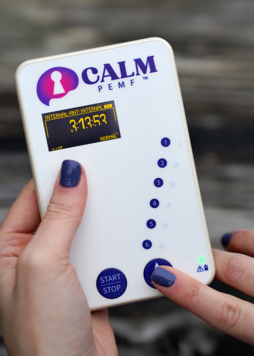 A person using the CALM PEMF™ device to maintain tranquility.